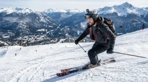 A photorealistic illustration of a man skiing downhill at Whistler Blackcomb, Canada, wearing a grey merino wool base layer visible under his technical gear.