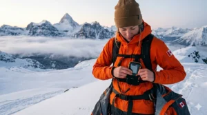 A photorealistic 4K illustration featuring a female backcountry skier in the Canadian Rockies, showing the correct placement of an avalanche beacon secured in its harness and worn beneath her orange technical mid-layer.