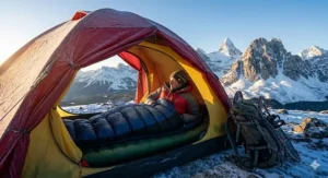 Winter camper using a heavy-duty sleeping bag for Arctic conditions in Banff National Park, Canada.