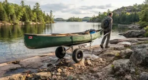 A reliable folding canoe cart rolling smoothly across a rocky Canadian Shield shoreline