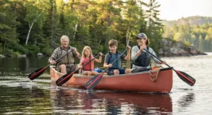 A family enjoying a day out on the water, equipped with a durable and lightweight canoe paddle for all skill levels.
