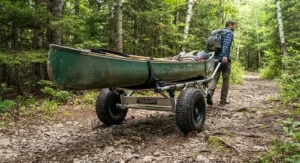 A heavy-duty folding canoe cart equipped with durable all-terrain wheels for navigating gravel and dirt paths
