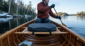 Thick insulated canoe seat cushion keeping a paddler warm during early spring expeditions.