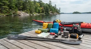 Essential sea kayaking expedition gear neatly laid out, featuring a lightweight kayak paddle for touring ready for a multi-day trip in Ontario.