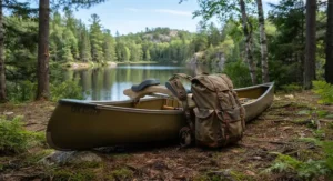 A solo canoe resting on a portage yoke with a tripping backpack attached for easy lake-to-lake travel.