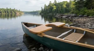A traditional wooden portage yoke for canoe fitted across the gunwales in a pristine wilderness lake setting in Ontario.