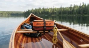River guide wearing a specialized waist-mounted throw bag for canoe rescue during an expedition.